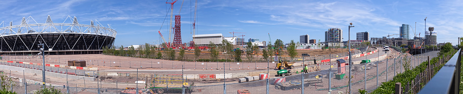 London, United Kingdom - May 3, 2011:  A panoramic view of the Olympic site can be seen behind a security fence. The parcel of land that will host the 2012 Olympic Games is approximately 1.7 x 1.7 sq. kilometers. The site was formerly occupied by bomb factories and industrial plants from World War II. All the land has been decontaminated. This site is being built with the environment and being green in mind. 