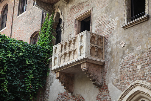 Verona, Italy – July 18, 2013: Famous balcony at the Juliet's House in Verona (northern Italy), one of the most popular attractions in the town, widely believed to be the place of William Shakespeare's love tragedy Romeo and Juliet.