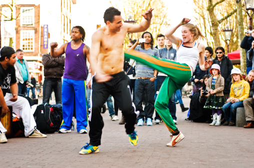 Amsterdam, Netherlands - April 9, 2011: Group of capoeiristas performing outside at Rembrandtplein