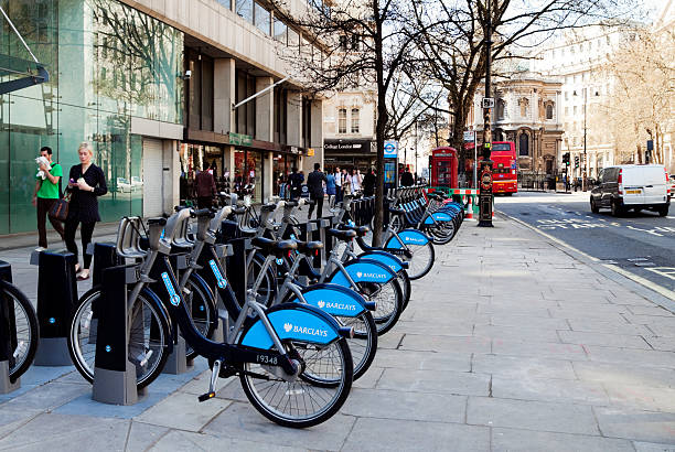 Row of "Boris's Bikes" in the Strand London, England - April 6, 2011: A row of "Boris's Bikes", as they are affectionately known, parked in the Strand, London. The Mayor of London, Boris Johnson, has introduced a cycle-hire scheme in conjunction with Barclay's Bank, to encourage people to cycle in London instead of using their cars, thereby reducing traffic congestion, pollution and parking problems. Around 6,000 bikes are stored at 400 docking stations like this one. boris bus stock pictures, royalty-free photos & images