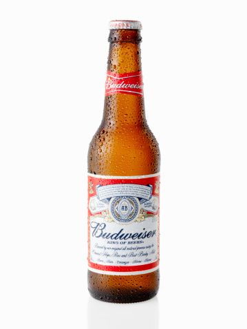Calgary, Canada - April 3, 2011: A 12oz, American Bottle of Budweiser Beer shot in Studio on white with Natural Reflection, Budweiser is made by the Anheuser-Busch Company.