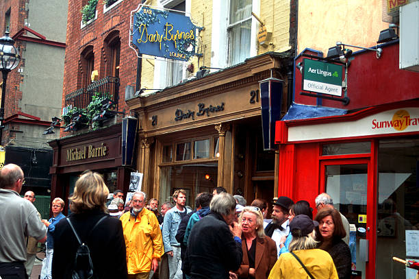 Bloomsday at Davy Byrnes Dublin, Ireland - June 16th 2005: Bloomsday celebration in Dublin, homage to the writer James Joyce. This bar is mentioned in his novel Ulysses and many dubliners go on Bloomsday (16 june) to eat a gorgonzola cheese sandwich and drink a glass of burgundy wine, as Leopold Bloom, the protagonist of the novel. bloomsday stock pictures, royalty-free photos & images