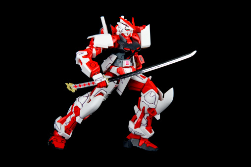 Vancouver, Canada - April 13, 2013: A model of the MBF-P02 Gundam Astray Red Frame Mecha from the Gundam series of Animated TV shows. The model is posed on a black background and is manufactured by Bandai