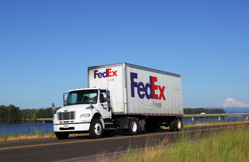 Portland, Oregon, USA - July 1, 2011: A FedEx Freight truck making deliveries in the Portland area. The Columbia River and Mt Hood are in the background.