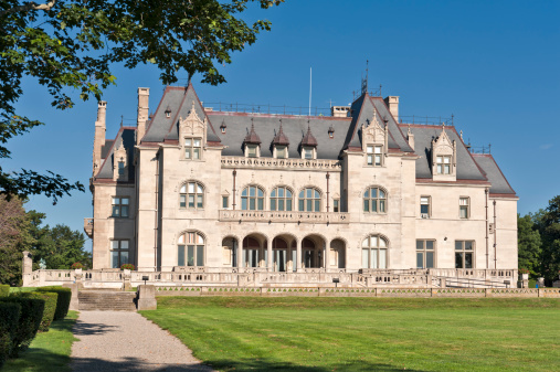 Newport, Rhode Island, USA - August, 10th 2008: Commissioned by Gilded Age banker and developer, Ogden Goelet, as his family's summer residence, Ochre Court (1888-1892) is the first of a group of spectacular houses in the Grand Manner designed by Richard Morris Hunt, America's foremost architect of the late nineteenth century. The mansion was gifted, in 1947, by Ogden's son, Robert, to the Religious Sisters of Mercy who established Salve Regina College. Viewed from the public cliff walk.