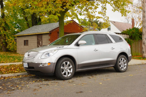 Hamilton, Canada - October 27, 2013: Silver colored Buick Enclave luxury crossover SUV parked on the street.