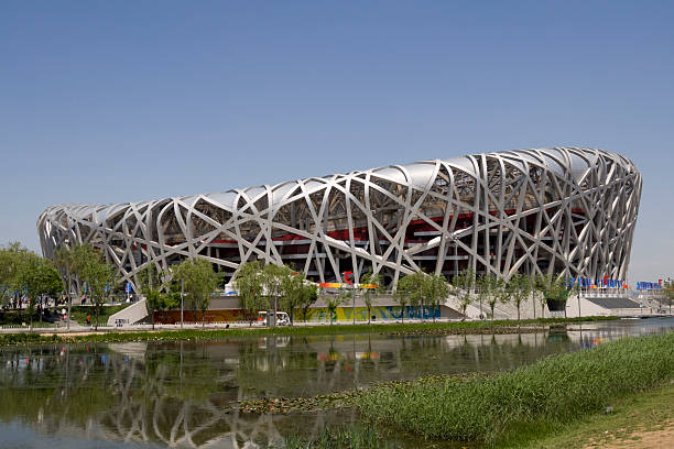 Bird's nest stadium in Beijing Beijing, China - May 19th 2010: The Bird's nest stadium constructed for the 2008 Olympic games. There is a lake in the foreground and clear blue sky overhead. beijing olympic stadium photos stock pictures, royalty-free photos & images