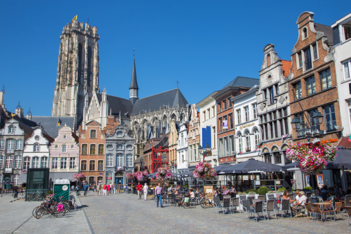Mechelen, Belgium - September 4, 2013: Grote markt and St. Rumbold's cathedral and number of tourists.