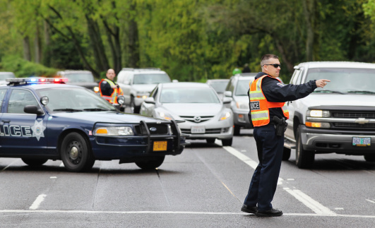 Eugene, Oregon, USA - April 29, 2011: Police officers direct traffic around an obstruction.
