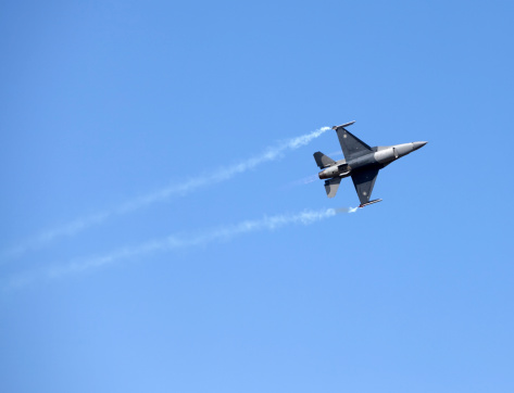 Izmir, Turkey - June 3, 2011 : A Pakistani JF-17 combact aircraft named Thunder, in flight, demonstrating the skills of the pilot and the aircraft using white smoke dispensers to enhance the demonstration.The fighter craft was a participant in the 2011 Air Show Turkey - held in celebration of the 100th anniversary of the Turkish Air Force at the Cigli Air Base, Izmir.The JF-17 is a light-weight, single engine, multi-role combat aircraft developed jointly by the Chengdu Aircraft Industries Corporation (CAC) of China, the Pakistan Air Force and the Pakistan Aeronautical Complex (PAC).