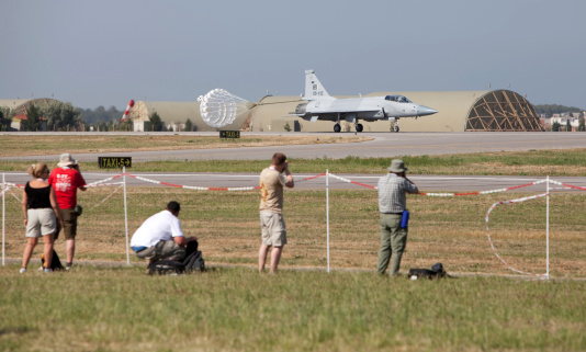 Izmir, Turkey - June 3, 2011 : Photographers photograph a recently landed, Pakistani F-16 called Baaz 371, participating in the 2011 Air Show Turkey - held in celebration of the 100th anniversary of the Turkish Air Force at the Cigli Air Base, Izmir.F-16 Fighting Falcon is a multirole jet fighter aircraft originally developed by General Dynamics for the United States Air Force.It was designed as a lightweight day fighter and has now been evolved into a successful all-weather multirole aircraft.