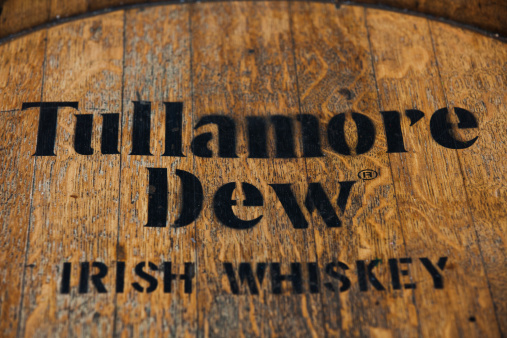 Dusseldorf, GERMANY - September 4, 2013: Tullamore Dew Irish whiskey brnadmark on rustic whiskey jar.