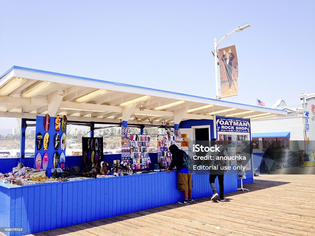 Oatman Rock Shop on Santa Monica Pier Santa Monica, USA  - May 31, 2013: Oatman Rock Shop on Santa Monica Pier, selling a mixture of classic 60s merchandise of crystals and shells and Santa Monica Souvenirs: jewelry, hand crafted art etc. Two men buying gifts. Adult Stock Photo
