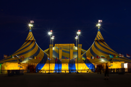 Toronto, Canada - September 10, 2009: Cirque du Soleil tent illuminated during a show while a helper standing in the foreground.