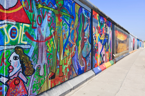 Berlin, Germany - April 24, 2011: East Side Gallery wall of Berlin Germany. Graffiti paintings on the Berlin wall that are part of the East Side Gallery,it is a long section of the original Berlin wall that has been transformed in a freedom memorial. Around 100 artists from all over the world painted in 1990 this section of the wall. The paintings are now restored after they suffered badly from vandalism that damaged badly the original ones.This graffiti is by artist Kim Prisu.