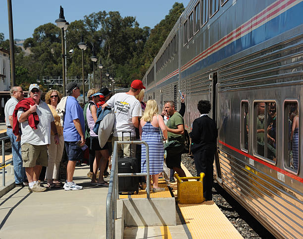 San Luis Obispo Station San Luis Opispo, United States - June 21, 2013: Unidentified passengers wait to board the northbound Amtrak 'Coast Starlight' train at San Luis Obispo station in California, USA. This train, composed of both standard coaches and sleeping cars, makes a daily journey of 1377 miles in both directions between Los Angeles and Seattle. Amtrak stock pictures, royalty-free photos & images