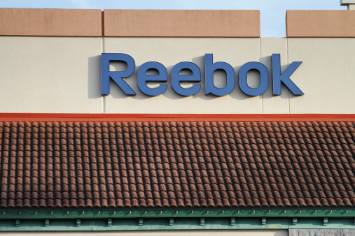 St Augustine, FL, USA - March 14, 2011: The Reebok brand name on the exterior wall of a outlet store building. Reebok is a subsidiary of Adidas and a distributor of its own branded sporting products.