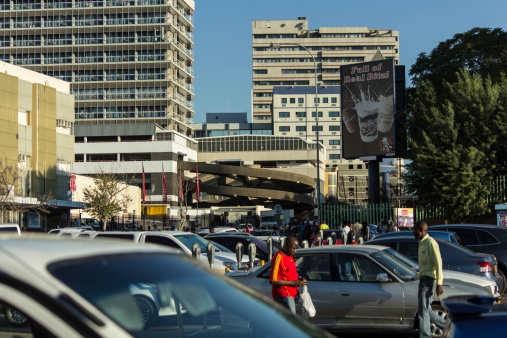 Windhoek, Namibia - April 30, 2013: People walking and standing around a big parking lot in the hart of Windhoek just behind the main shopping street.