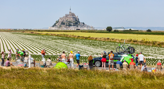 Ardevon,France- July 10, 2013: The Slovak cyclist Peter Sagan passing through rows of spectators on the roadsides in front of Le Mont Saint Michel Monastery during the stage 11 of edition 100 of Le Tour de France 2013, a time trial between Avranches and Mont-Saint-Michel. Sagan was the winner of the Green Jersey,granted to the fastest sprinter, in this centennial edition of the famous competition.