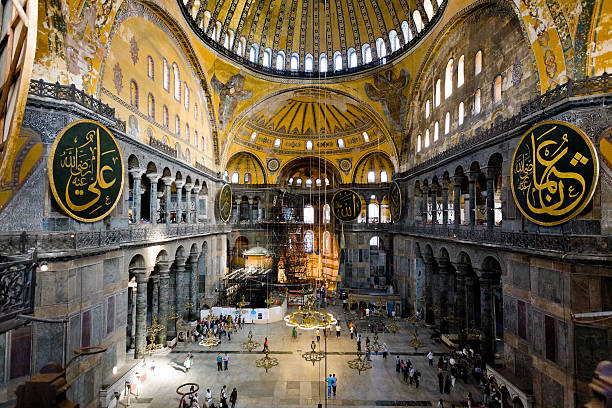 Interior of Aya Sophia - ancient Byzantine basilica Istanbul, Turkey - September 10, 2010: tourists visiting the interior of Aya Sophia - ancient Byzantine basilica. For almost 500 years the principal mosque of Istanbul, Hagia Sophia served as a model for many other Ottoman mosques hagia sophia istanbul photos stock pictures, royalty-free photos & images