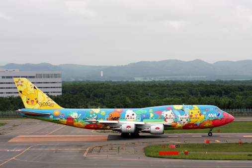 SAPPORO, JAPAN - June 15, 2009: Boeing 747-400 of All Nippon Airways (ANA) decorated with images of different Pokemons on runway before taking off in New Chitose Airport, Hokkaido, Japan