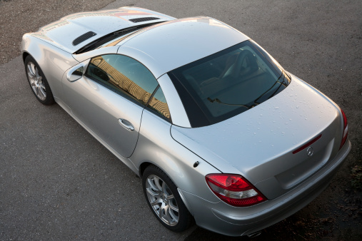 Aalen, Germany  - January 14, 2007: A silver Mercedes-Benz SLK Class outside of a car dealership. The SLK is the compact roadster, one of the first modern retractable hardtop convertibles, it's built in Bremen, Germany.