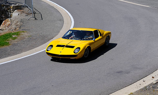 Lamborghini Miura S classic Italian sports car Spa Francorchamps, Belgium - June 28, 2008: Classic yellow Lamborghini Miura S supercar driving on a road at the circuit of Spa Francorchamps during the Spa Italia Days. lamborghini miura stock pictures, royalty-free photos & images