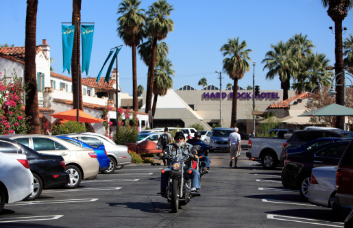 Palm Springs, United States- October 25,2013:   Two bikers coming toward camera at the annual 3 day motorcycle rally in Palm Springs California.  The Hard Rock Hotel is seen in the background.