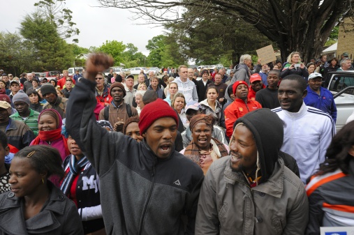 Underberg, South Africa - October 22, 2013 - A community unites  in a public  demonstration at the local court  to protest the brutal bludgeoning to death of Dan Knight