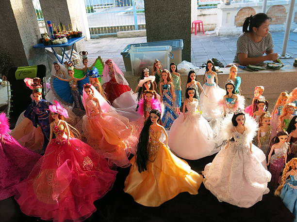 Bangkok, Thailand aa November 17, 2013: Selling fashion dolls wearing different styles of clothes. The dolls are sold by vendors on the sidewalk in Bangkok, Thailand.