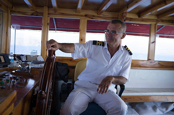 Fethiye, Turkey - July 27, 2013:  Captain of a boat traveling around the islands in Fethiye, Turkey.  Many wooden boats take travelers around the Aegean Sea to visit islands and spend the day enjoying the beautiful Aegean Sea.