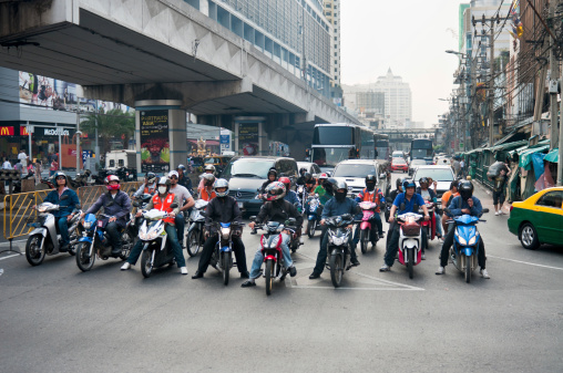 Bangkok, Thailand - March 3, 2011: Motorcycles and cars waiting at a busy junction on Ratchaprarop road in Bangkok, Thailand.