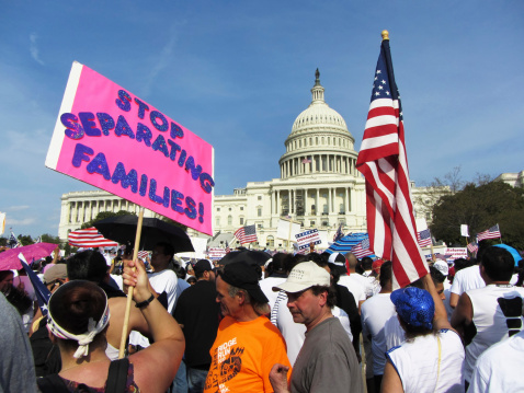 Washington D.C., USA-April 10, 2013:  Latino protesters rally in front of the U.S. Capitol building in Washington D.C. in order to reform immigration laws in the United States.  Barack Obama was elected with the Latino vote and promised immigration reform.  Family separation is one of the issues being protested.