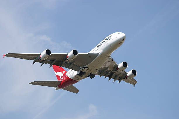 London, United Kingdom - May 4, 2011: World largest passenger aircraft Airbus A380 in Qantas color scheme (reg. VH-OQF) taking off at Heathrow Airport in almost cloudless sunny day. Front view of the plane with main landing gear doors still open. A380 maximum certified carrying capacity is 853 passengers. One of Qantas A380 powered with Rolls-Royce Trent 900 had an uncontained engine failure with structual damage and was forced to make emergency landing at Singapore airport.