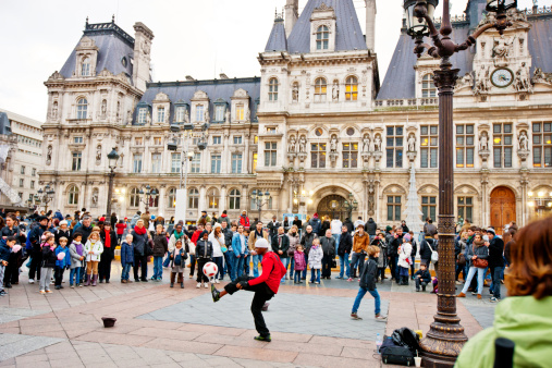 Paris, France - December 28, 2012: Street Performance and crowd of spectators looking at it near Hotel De Ville, Paris