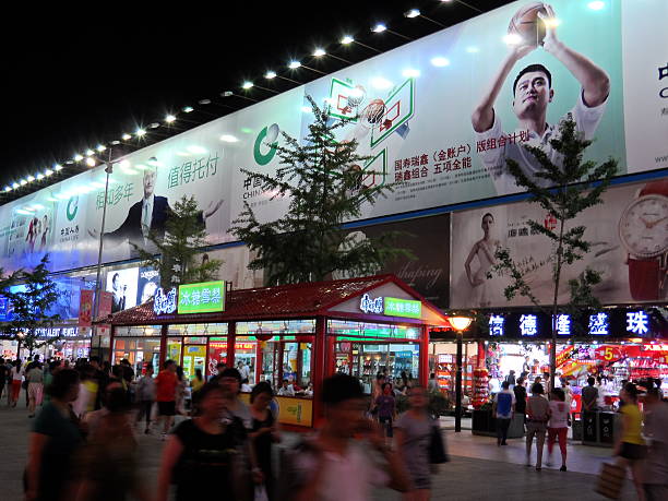 Yao Ming advertisement in China Beijing, China aa July 2, 2013: Yao Ming advertisement in Wangfujing Street, Beijing, China. Many people go shopping and walk past this advertisement. wangfujing stock pictures, royalty-free photos & images