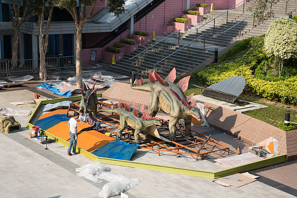 Hong Kong, China - October 26, 2013: People preparing the robotic dinosaurs in Tsim Sha Tsui East, Kowloon, Hong Kong. It is the largest exhibition of dinosaurs in Hong Kong.
