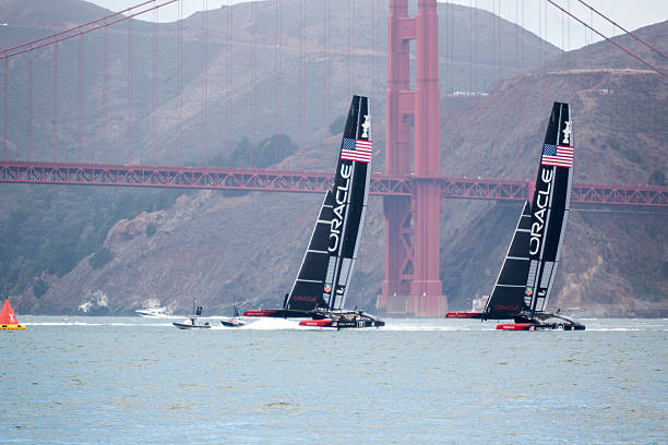 A yacht sails upwind behind another trying to make up distance.