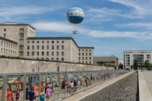 Berlin, Germany - July 24: Remains of Berlin Wall and Welt Balloon that takes tourists 150 meters into the air above the city