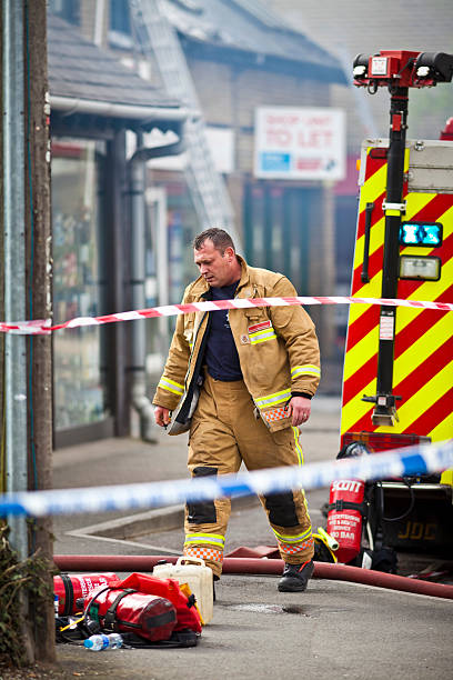 fireman valientes y cansado después de la lucha contra los incendios - uk fire department fire engine team fotografías e imágenes de stock