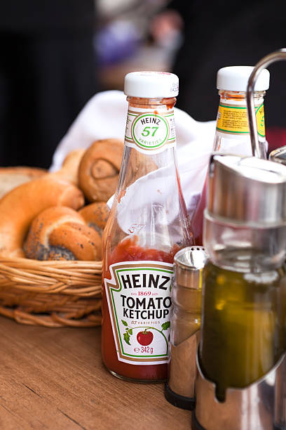 Prague, Czech Republic - April, 1 2011: Heinz tomato ketchup with bread, salt and paper and olive oil, on the table, restaurant detail from Prague, Czech Republic.