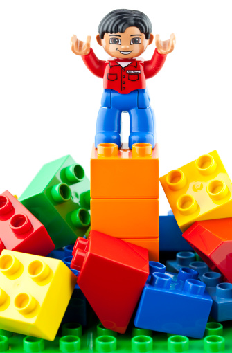 Suffolk, Virginia, USA - April 12, 2011: Studio shot of Lego brand Duplo toy blocks and a Duplo man with his arms outstretched.