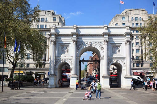 London, United Kingdom - April 19, 2011: Tourists taking pictures at the Marble Arch at Hyde Park in London, United Kingdom. The Marble Arch was built by John nash in 1828 out of Carrara marble. Formerly this place was known as a place of public execution with three-legged gallows.