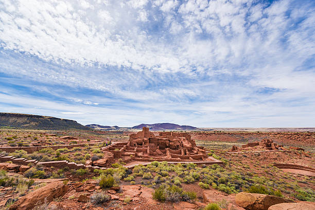 Panorama Ruins of Wupatki Pueblo in Arizona, USA Wupatki Pueblo, Arizona, USA - May 25th, 2013: Tourists are taking picture of ruins of Wupatki Pueblo in Wupatki National Monument, Arizona, USA. puebloan peoples stock pictures, royalty-free photos & images