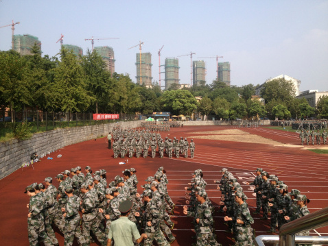 Zhenjiang, China - September 14, 2013: According to the Law of the People's Republic of China on National Defense Education, undergraduate students take formal military training and emergency evacuation t Jiangsu University, Zhenjiang, Jiangsu, China. Training usually lasts 10aa15A days for boys, but only 6aa7A days for girls.Photo taken from Zhenjiang City, Jiangsu Province, China. Photo taken with Apple iPhone.