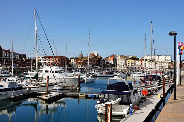 Harbour of Ramsgate Kent, UK Ramsgate, Kent, UK - August 19, 2013: View of Ramsgate inner harbour. The yachts are in front of the city and the harbour street with pubs and restaurants. ramsgate stock pictures, royalty-free photos & images