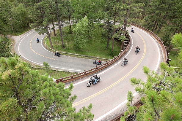 Motorcycle Corkscrew Road Trip Black Hills,South Dakota, USA - August 7, 2013: 2013 Sturgis Motorcycle Rally Week,a group of motorcyclists out on their Harley Davidson motorcycles riding the country corkscrew roads. black hills photos stock pictures, royalty-free photos & images