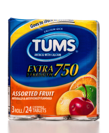 Miami, USA - August 25, 2013: TUMS Extra Strenght 750 antiacid with calcium 3 rolls packet. TUMS brand is owned by GlaxoSmithKline.