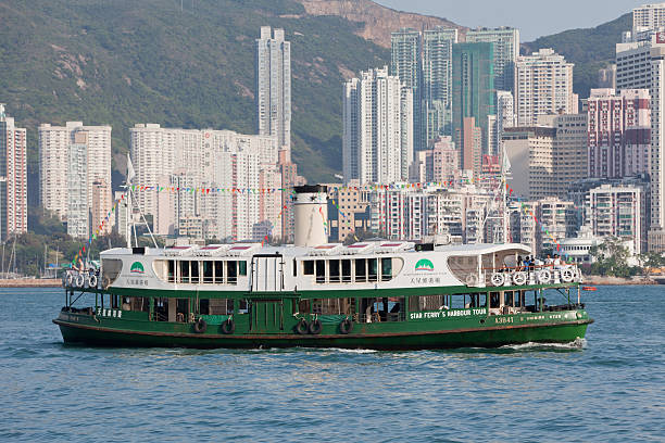 Hong Kong, China - April, 24th 2011: A Star Ferry at the Victoria Harbour. Star Ferry\\'s Harbour Tour plies its way between Hong Kong Island and Kowloon. This picture shows the SHINING STAR Star Ferry on Victoria Harbor, Hong Kong. Many tourists are on the ferry.