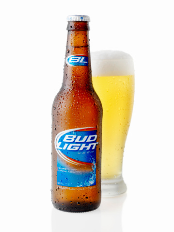 Calgary, Canada - April 5, 2011: A 12oz, American Bottle and Glass of Bud Light shot on white, Bud Light is made by the Anheuser-Busch Company.